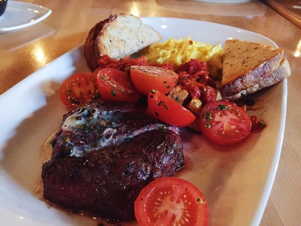 'Steak and eggs' consists of a flatiron steak, free-run eggs heirloom tomato salad, and our beloved patatas bravas.