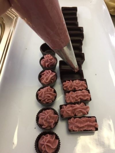 Filling buttercream into chocolates