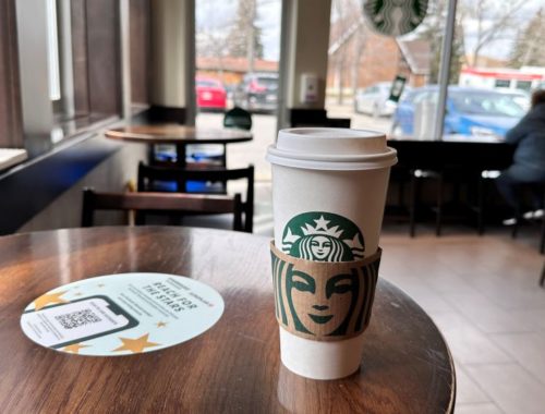 Starbucks coffee beverage in a disposable paper cup.