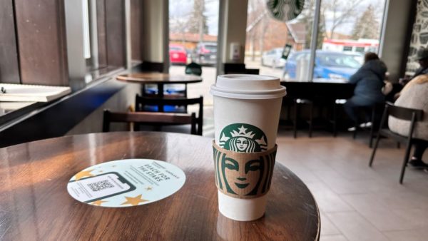 Starbucks coffee beverage in a disposable paper cup.